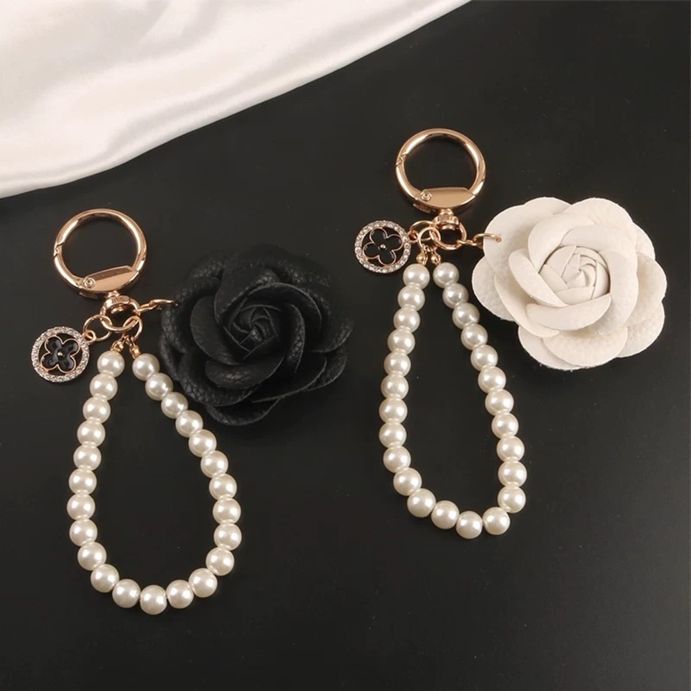 Elegant Pearl Keychain with Black and White Floral Accents